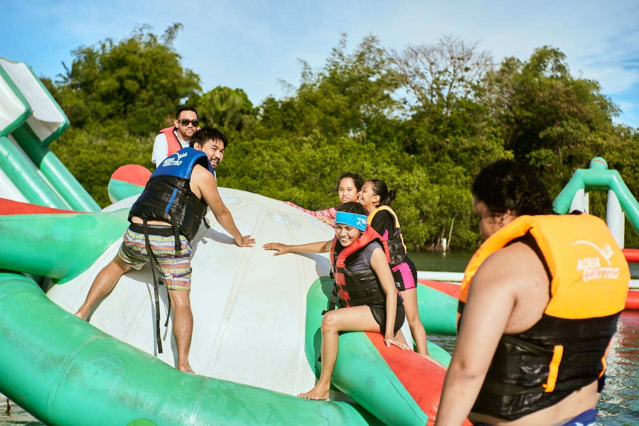 Services Group enjoying summer day at a water park with inflatable structures. Perfect for travel and leisure imagery.